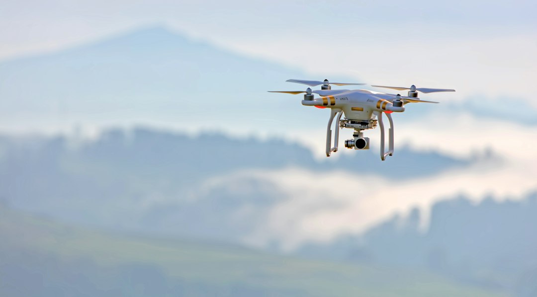 Wireless Power Beaming for Drones: GuRu Demonstrates Persistent Flight A quadcopter drone hovering in flight during a technology test